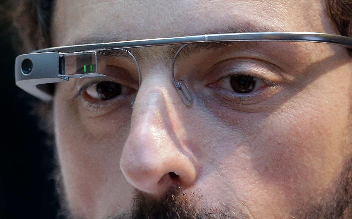Google co-founder Sergey Brin wears a Google Glass device in 2013. Google says it will stop selling its Internet-connected eyewear to consumers until it can develop a more polished version.
