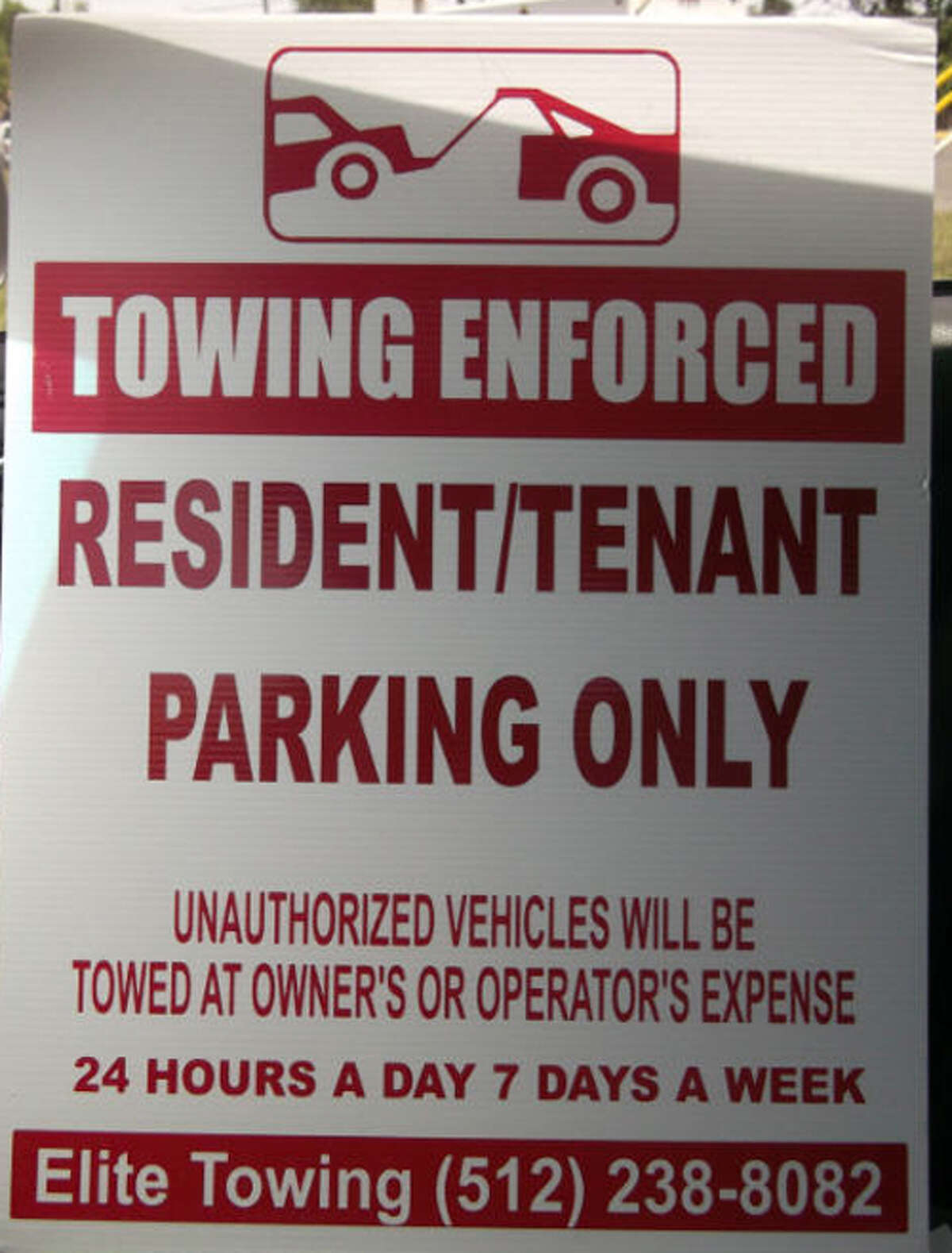 LEGAL SIGNAGE: While owners of private property are allowed to have unwanted vehicles towed from their premises at the expense of the vehicle's owners, the Texas Department of Licensing and Regulation sets very specific requirements of what tow signs must read and the maximum amount owners may have to pay to reclaim their vehicle. The signs, collected by included by the fair towing advocates at Texas Towing Compliance are examples of signs which may be outdated, charge above the maximum for towing, may be incorrectly displayed, contain incorrect verbiage of possibly violate tow sign regulations. What makes this sign legal? The sign is posted in the proper colors, features the universal towing symbol, is clearly visible, posts times in which towing is in affect, includes contact number and explains that towing will be at owner's expense.