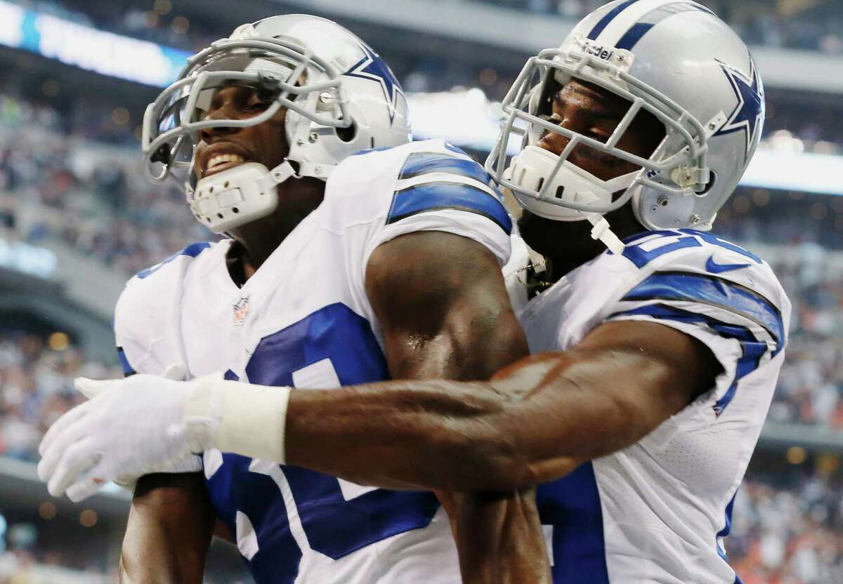 Dallas Cowboys wide receiver Dez Bryant (;eft) celebrates his touchdown with DeMarco Murray during the first quarter against the Denver Broncos on Oct. 6, 2013, in Arlington, Texas. Cowboys owner Jerry Jones says it will be a “challenge” to sign both Bryant and Murray, with free agency looming for one of the league’s top receivers and the NFL rushing leader.