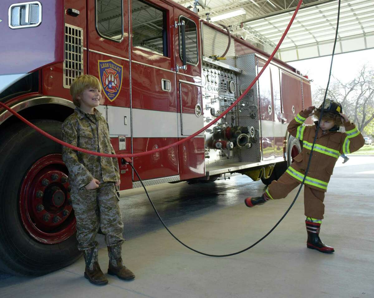 Caleb, left, and Cooper Valuk explore the new Leon Valley fire station on Jan. 16. Their grandfather was San Antonio firefighter.