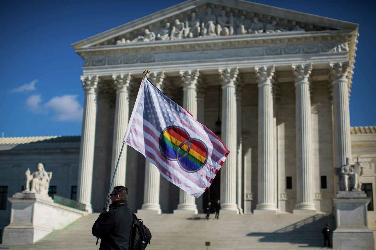 Pete Prete with Equality Beyond Gender waves a flag in support of gay marriage in front of the U.S. Supreme Court in Washington, Jan. 16, 2015. The court on Friday agreed to decide whether all 50 states must allow gay and lesbian couples to marry. The courtâs announcement made it likely that it would resolve one of the great civil rights questions of the age before its current term ends in June. (Jabin Botsford/The New York Times)