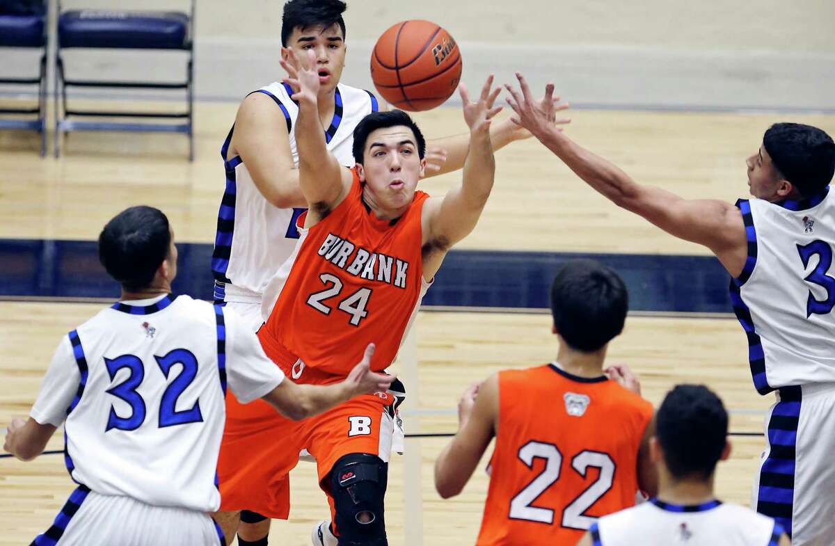 Burbank's Michael Mascorro grabs for a rebound between Lanier's Israel Serna (left) and Brian Laque during first half action Friday Jan. 16, 2015 at Alamo Convocation Center.