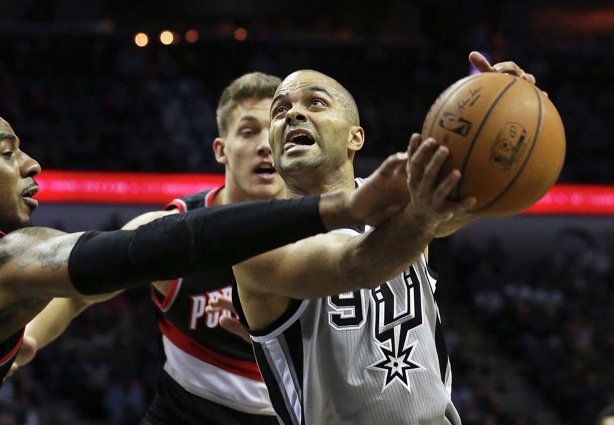 Tony Parker protects the ball from LaMarcus Aldridge as the Spurs play the Portland Trailblazers at the AT&T Center on January 16, 2015.