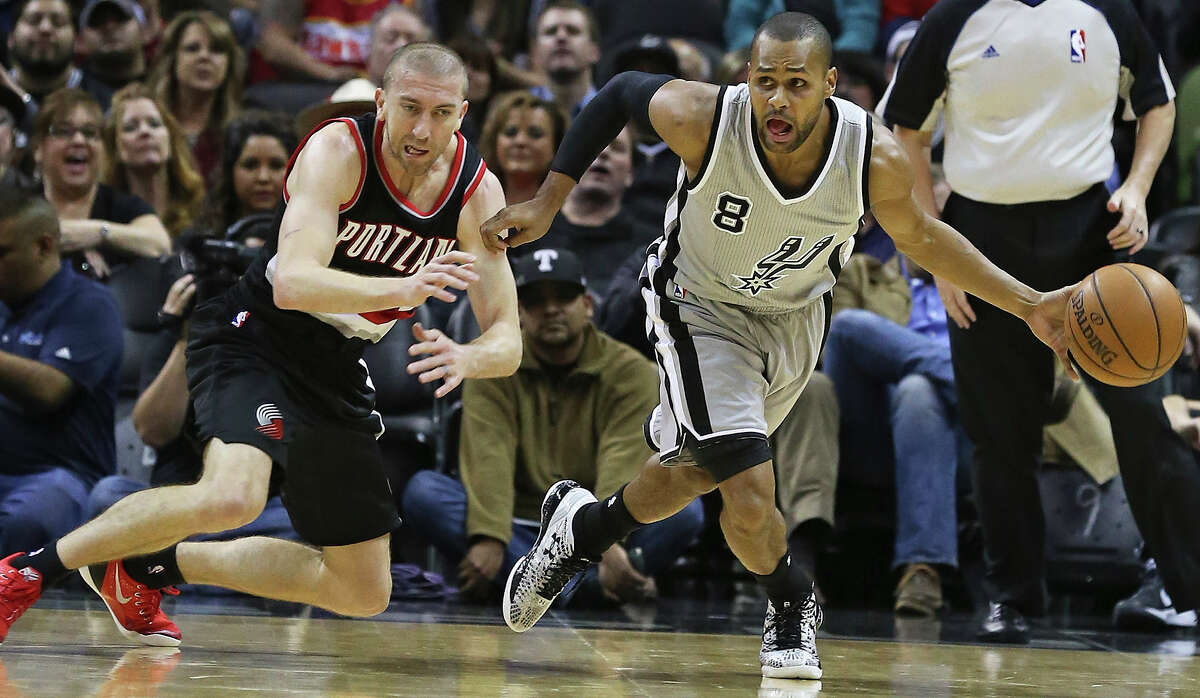 Patty Mills grabs a steal from Steve Blake as the Spurs play the Portland Trailblazers at the AT&T Center on January 16, 2015.