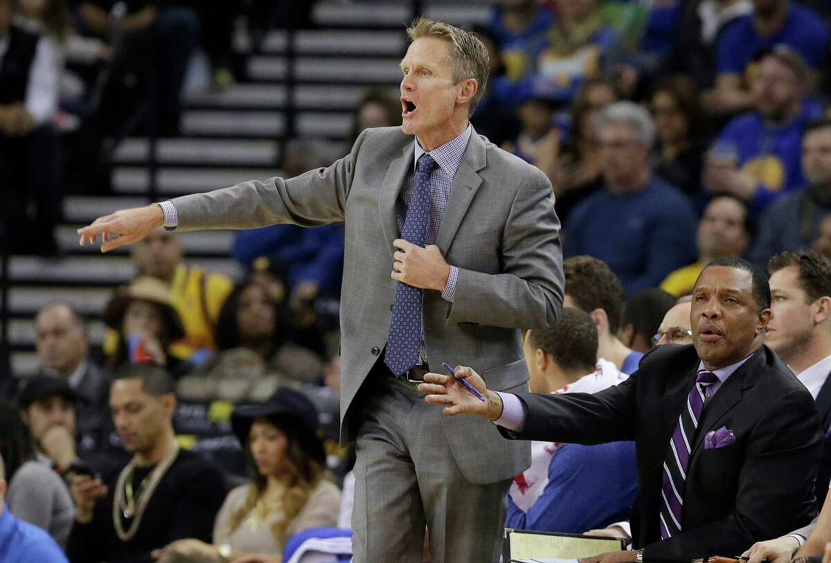 Golden State Warriors coach Steve Kerr, left, and assistant coach Alvin Gentry watch from the bench during the first half an NBA basketball game against the Miami Heat in Oakland, Calif., Wednesday, Jan. 14, 2015. (AP Photo/Jeff Chiu)