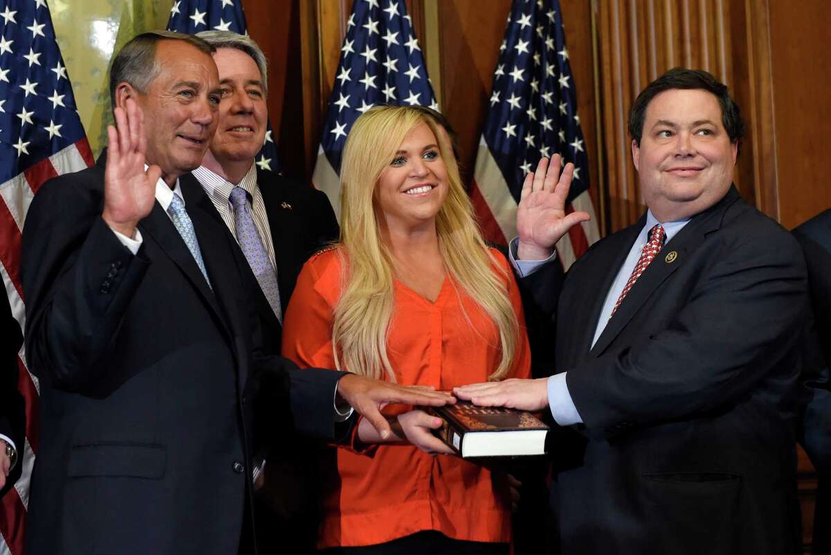 House Speaker John Boehner of Ohio poses for a photo with Rep. Blake Farenthold, R-Texas, right, accompanied by family, to re-enact the House oath-of-office, Tuesday, Jan. 6, 2015, on Capitol Hill in Washington. (AP Photo/Susan Walsh)