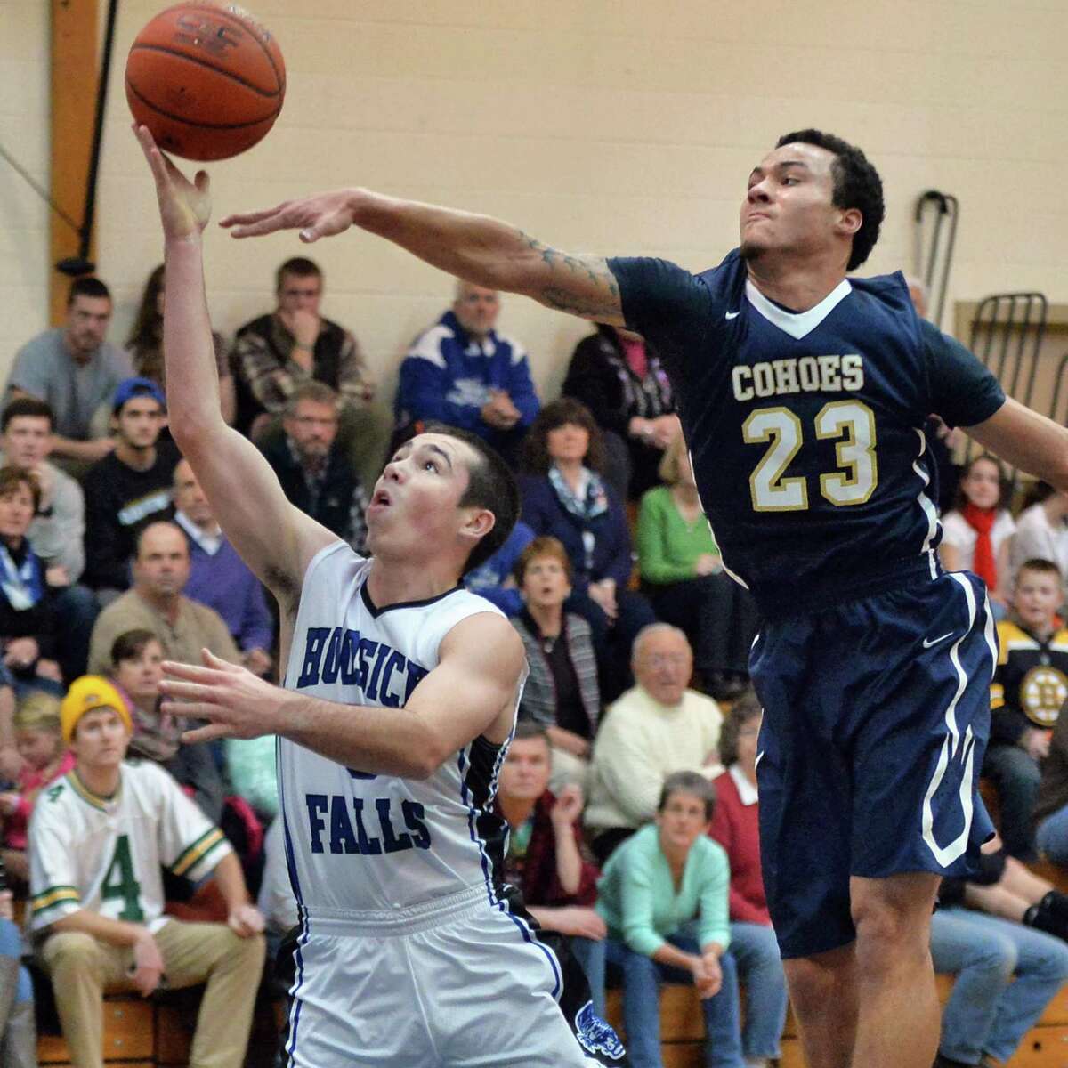 Hoosick Falls's #5 Andrew Hoag, left, goes to the basket guarded by Cohoes' #23 Shelton Alston during Saturday's game Jan. 17, 2015, in Hoosick Falls, NY. (John Carl D'Annibale / Times Union)