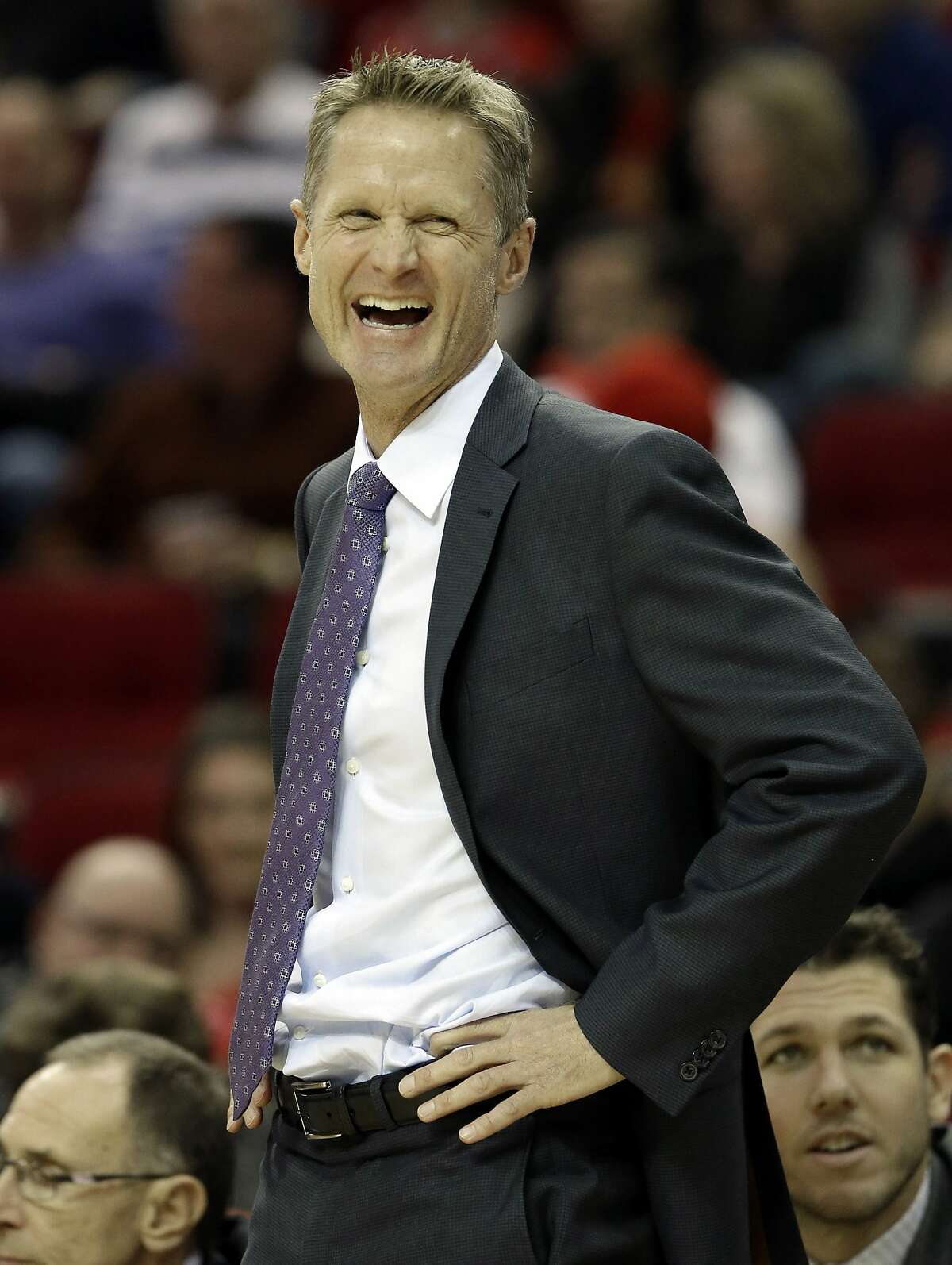 Golden State Warriors coach Steve Kerr laughs at a referee in the first half of an NBA basketball game against the Houston Rockets, Saturday, Jan. 17, 2015, in Houston. (AP Photo/Pat Sullivan)