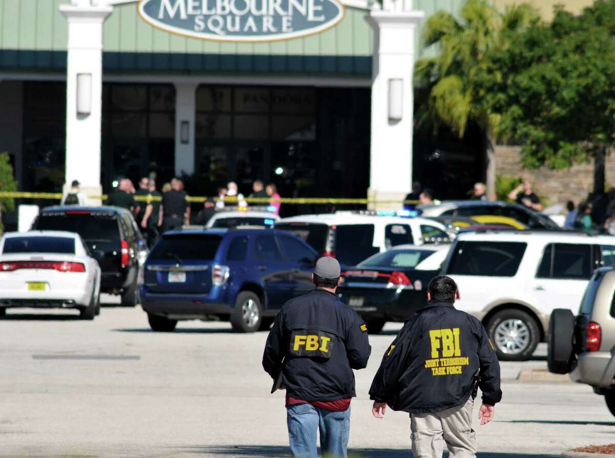 Law enforcement including the FBI respond to the scene of a shooting at the Melbourne Square Mall on Saturday, Jan 17, 2015 in Melbourne, Fla. Melbourne Police have confirmed that the shooting Saturday morning at the mall has left two people dead and one injured from a gunshot wound. Police say the injured victim is hospitalized in stable condition and cooperating with investigators. After responding to reports around 9:30 a.m. of multiple shots fired inside the mall, police tweeted that the "shooter is contained." (AP Photo/Florida Today, Malcolm Denemark) NO SALES