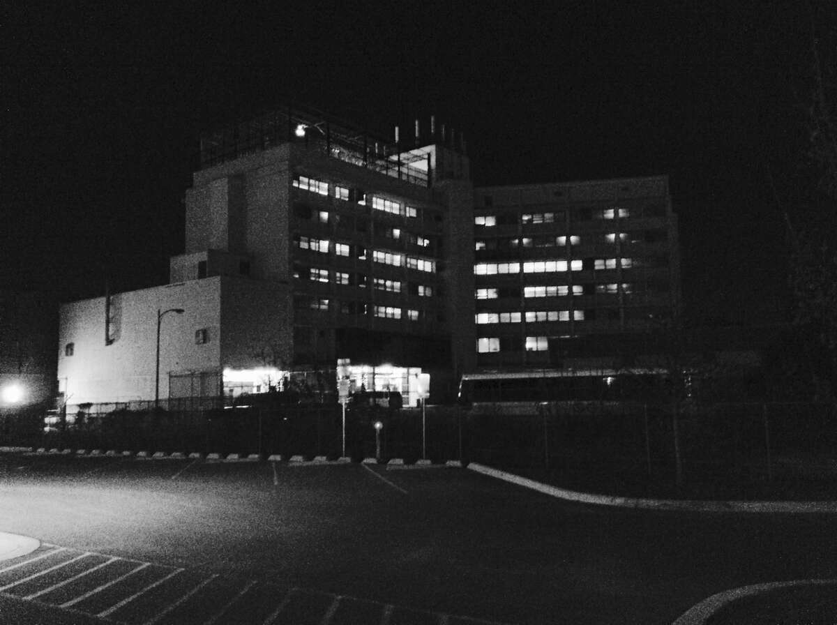 Once the Bexar County Jail, the Central Texas Detention Facility south of Dolorosa Street stands starkly in the darkness.