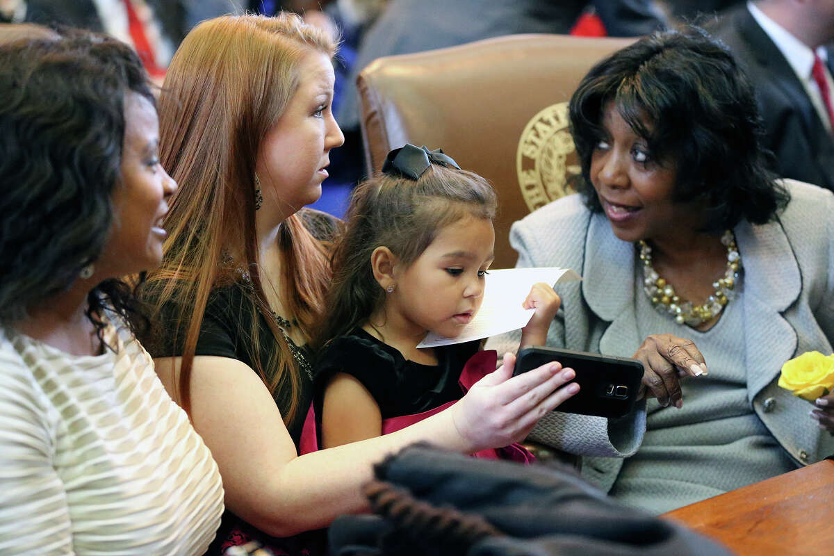 Rep. Ruth Jones McClendon chats with granddaughter Maliyah Jones, on lap of mom Vanessa Jones, and daughter Angela McClendon Johnson (left) during the opening-day ceremonies at the state Legislature.