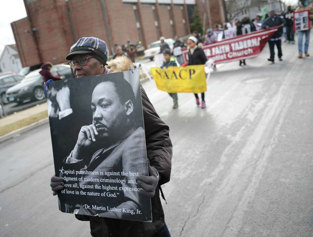 Annie Mobley, of Stamford, marches in the Martin Luther King march outside the Bethel A.M.E. Church in Stamford, Conn. Monday, Jan. 19, 2015. The church held a special service commemorating the life and ideals of The Rev. Dr. Martin Luther King, Jr. followed by a march through town with over 100 participants.