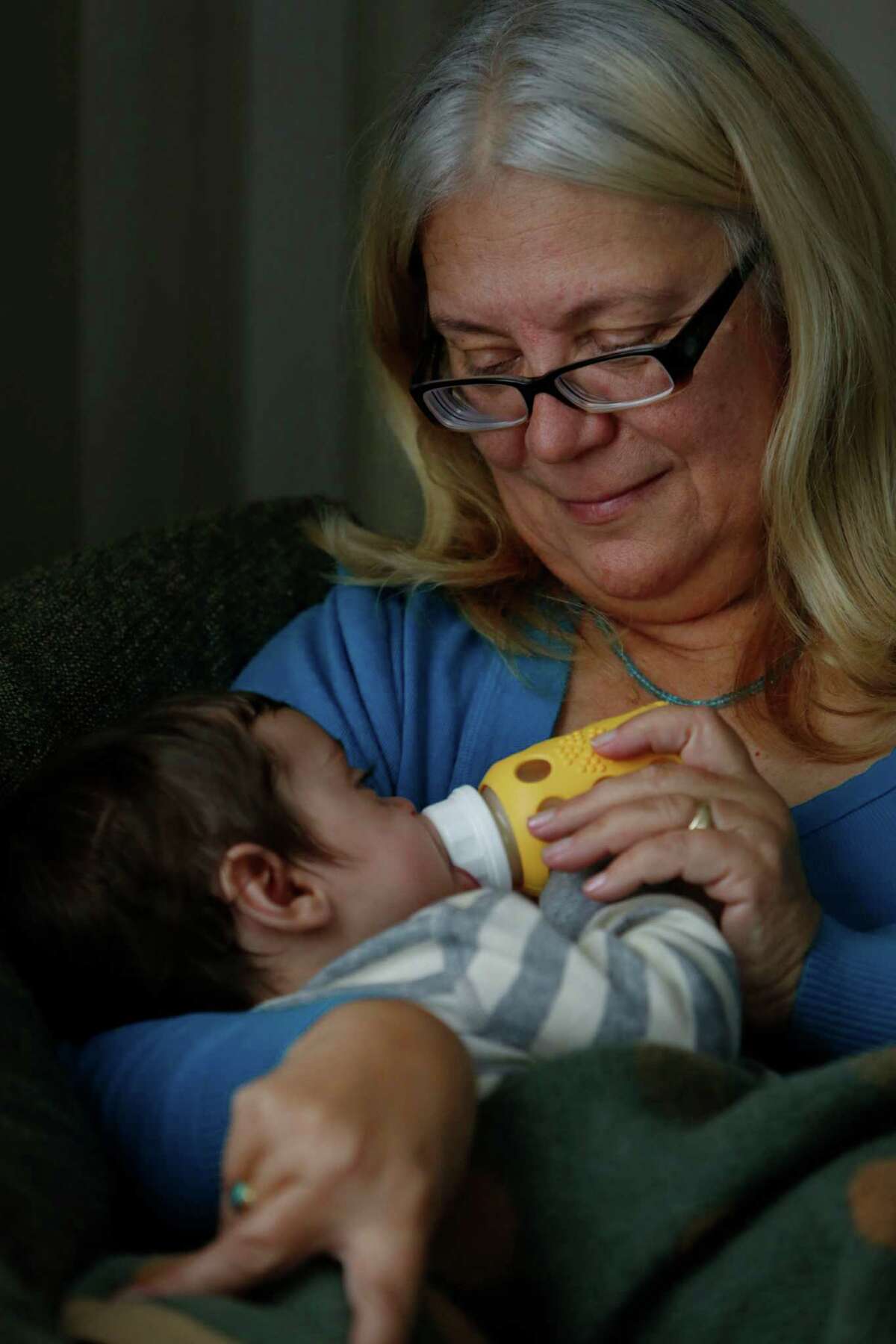 Susan Kraus, updated on the latest infant-care wisdom, gives 4-month-old grandson Xavier Raymond his bottle.