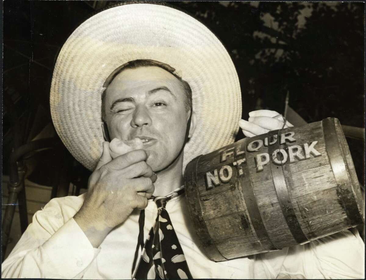 "Pappy" O'Daniel ﻿chomps on a peach and shows off his political treasure chest.