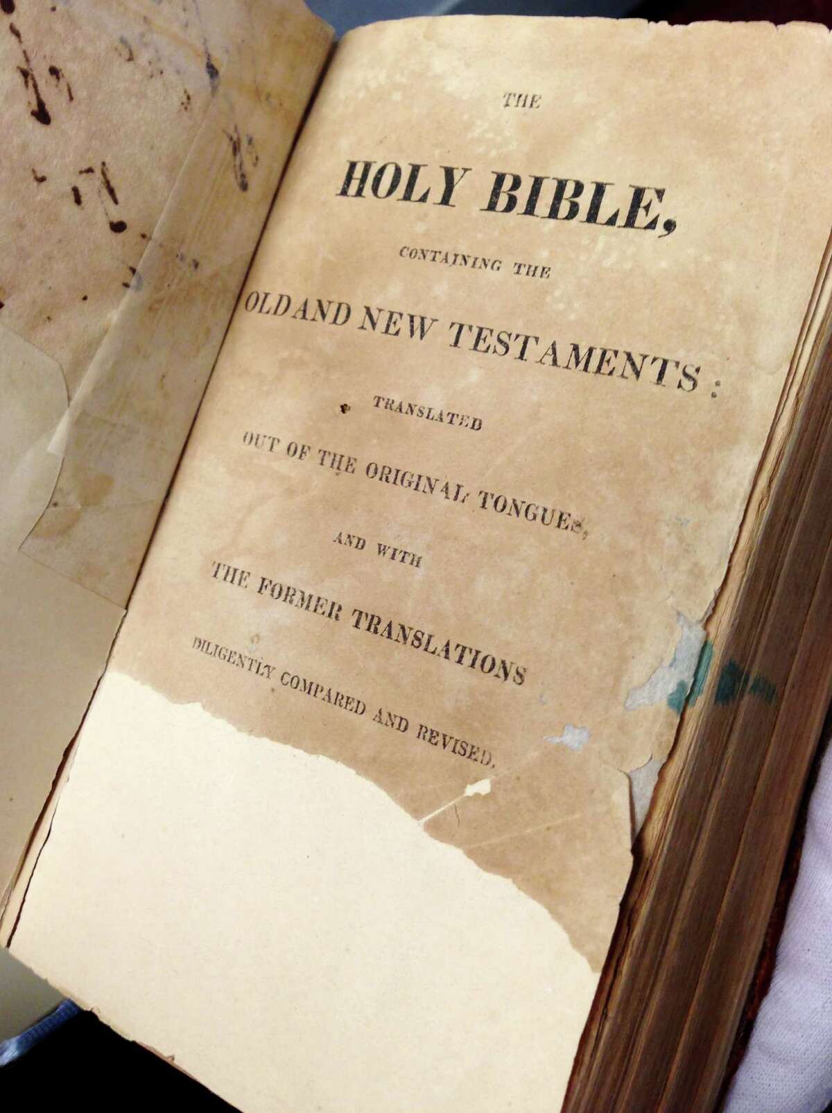 It was long thought Sam Houston’s signature was on the missing part of the torn page, but new evidence raises doubts about whose Bible this was. whether the Bible was his. it was his. This Monday, Jan. 12, 2015 photo shows the torn flyleaf inside of what has long been called the Sam Houston Bible, in Austin, Texas. Amateur historians have long thought that Sam Houston's signature was on the missing half of the page, but new evidence is raising doubts about whether the Bible used to swear-in Texas governors for nearly two centuries ever actually belonged to Houston. (AP Photo/Paul Weber)
