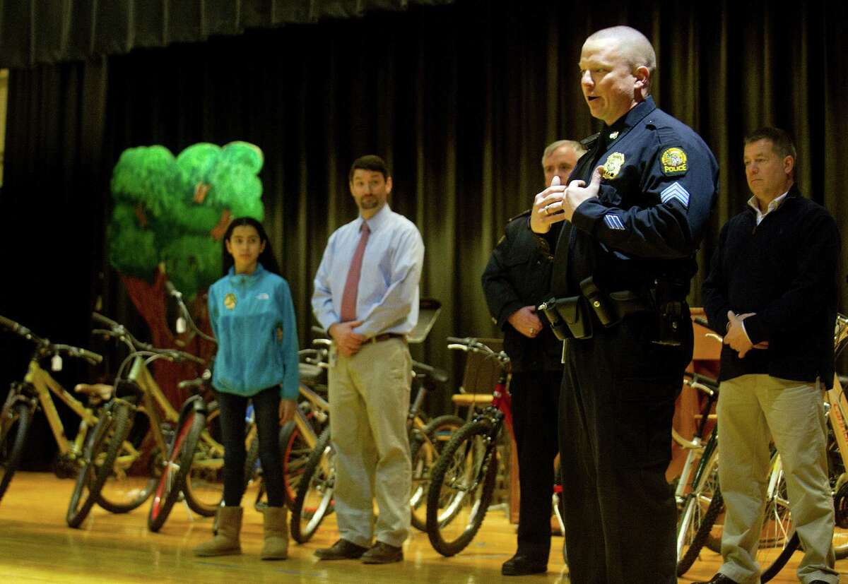 Greenwich Police Sgt. Timothy Hilderbrand speaks to Western Middle School students on Tuesday, January 20, 2015, to thank them for holiday cards sent by the students and to raffle bicycles.