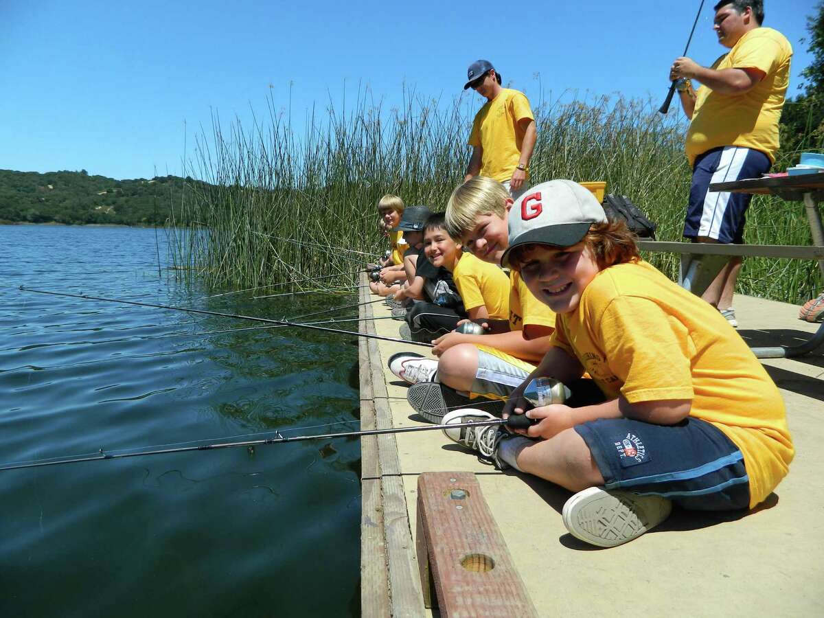 Campers fish at Lafayette’s Roughing It day camp. All the camp’s activities are outdoors.