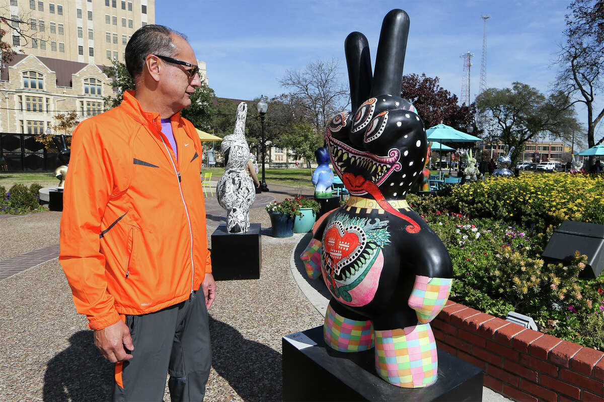 Danny Hernandez views a statue entitled "Xhuytl" by Mexican artist Jesus Alanis on display in Travis Park on Friday, January 16, 2015. Thirty life-size sculptures from Monterrey, Mexico, celebrating peace and reflecting a range of artists from Mexico and other countries, were unveiled Jan. 10 and comprise an exhibit called "Mano Factura: Arte Regio." They will be on display until March 5. MARVIN PFEIFFER/ mpfeiffer@express-news.net