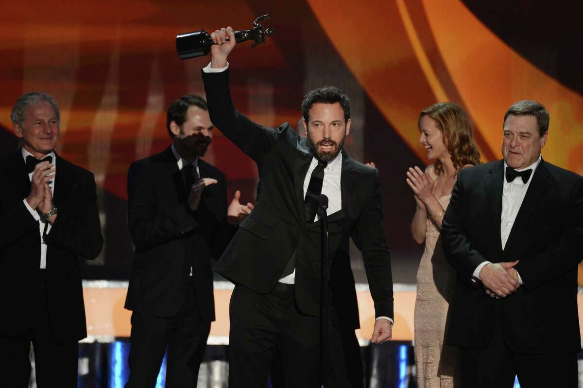 Ben Affleck (center), who played a Latino in “Argo,” accepts an Oscar for the Outstanding Performance by a Cast award.