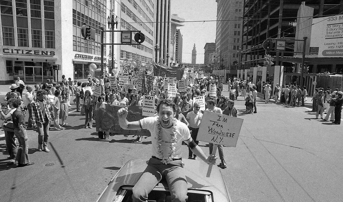 Harvey Milk rides on top of a car on Market St. at the 1978 at the Gay Freedom Day Parade, now known as San Francisco Pride. 06/25/1978 150 anniversary maybe