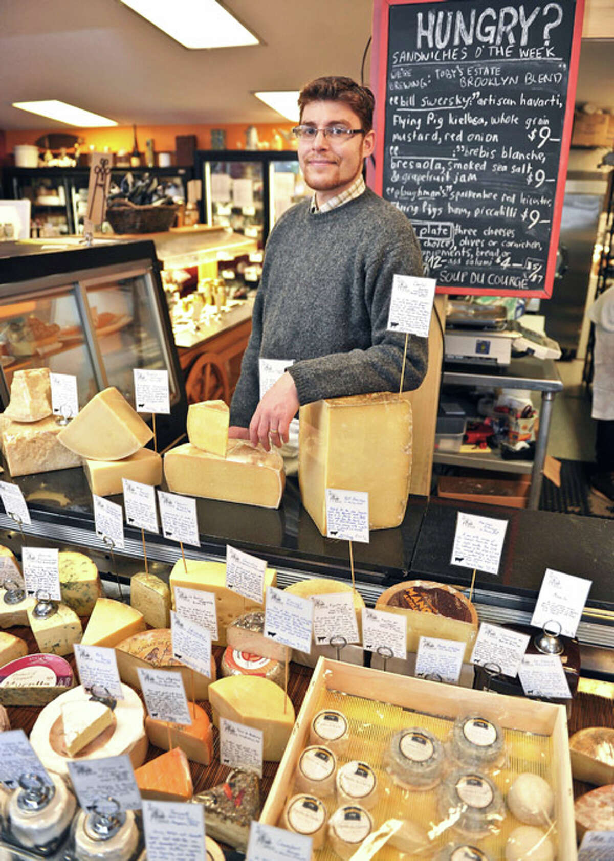 Eric Paul at the cheese counter of his store, The Cheese Traveler in Albany, NY.