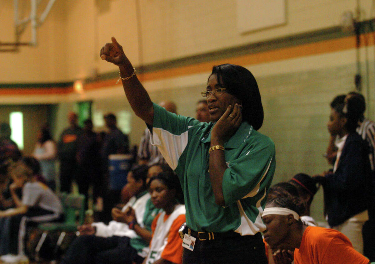 Milyse Lamkin directs her the Sam Houston High School girls basketball team in this 2005 file photo. Lamkin recently died after a hard-fought battle with cancer, and the girls she coached are determined to win in her honor.
