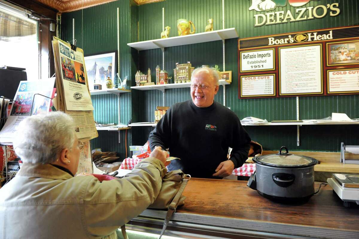 Business owner Rocco DeFazio, right, assists Lois Teitsch, a customer since 1965, on Wednesday, Jan. 21, 2015, at DeFazio's Deli in Troy, N.Y. (Cindy Schultz / Times Union)