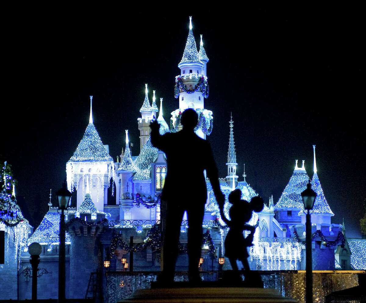 FILE - This Nov. 20, 2009 photo shows Sleeping Beauty's Castle in winter dress with the iconic "Partners" statue featuring images of Walt Disney and Mickey Mouse in the foreground, at Disneyland in Anaheim, Calif. Measles cases have been popping up around California in an outbreak linked to visits to Disneyland and Disney's California Adventure theme parks during the winter 2014 holiday. The highly contagious respiratory illness was declared eliminated in the U.S. in 2000, but health officials have seen a surge of measles infections in the country in recent years. (AP Photo/The Orange County Register, H. Lorren Au Jr., FILE) **; MAGS OUT; LOS ANGELES TIMES OUT**