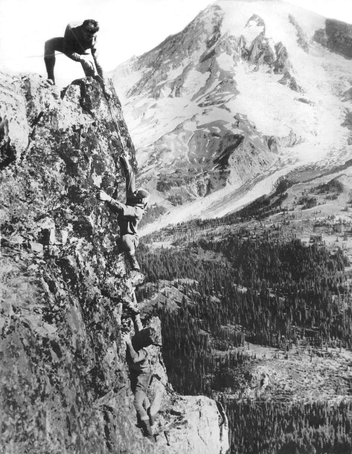 A party of three mountain climbers just as they are about to reach the top of Pinnacle Peak overlooking Paradise Valley, Mount Rainier National Park, Washington, August 15, 1925.
