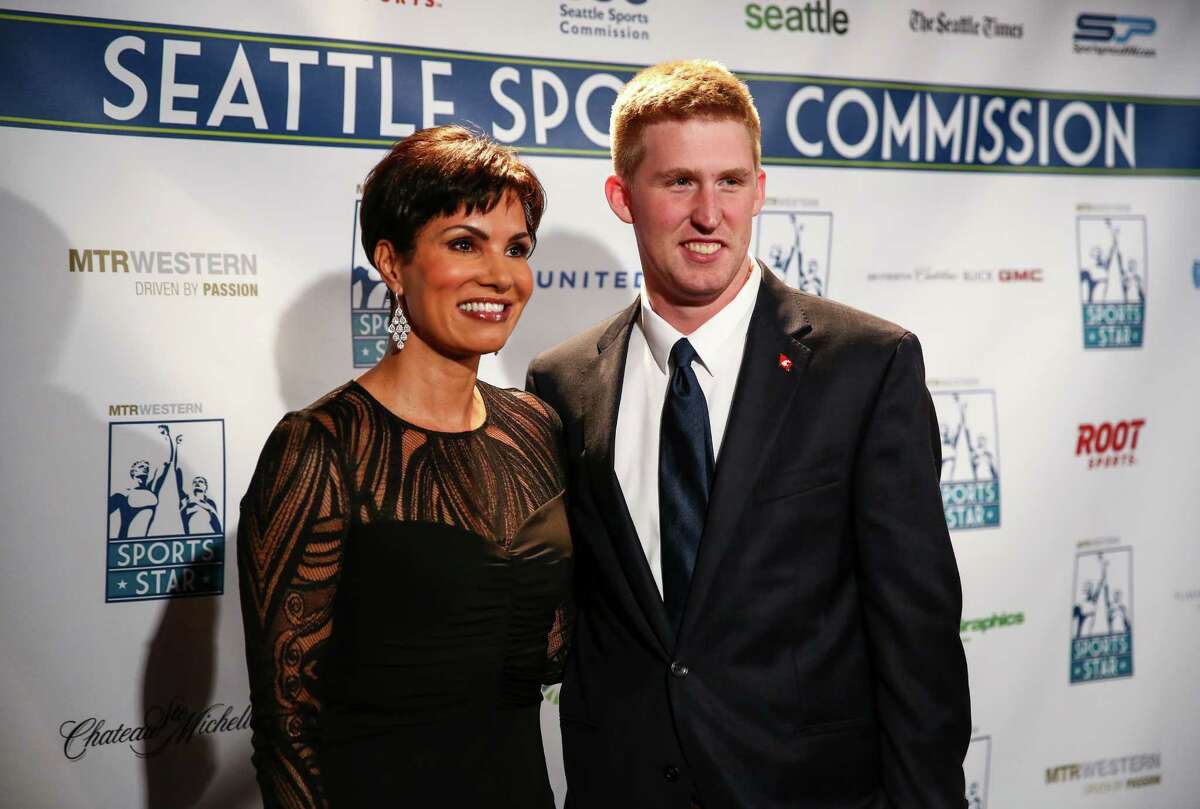 Television newscaster Cindy Brunson poses for a photo with Washington State University quarterback Connor Halliday during the annual Sports Star of the Year Awards at Benaroya Hall on Wednesday.