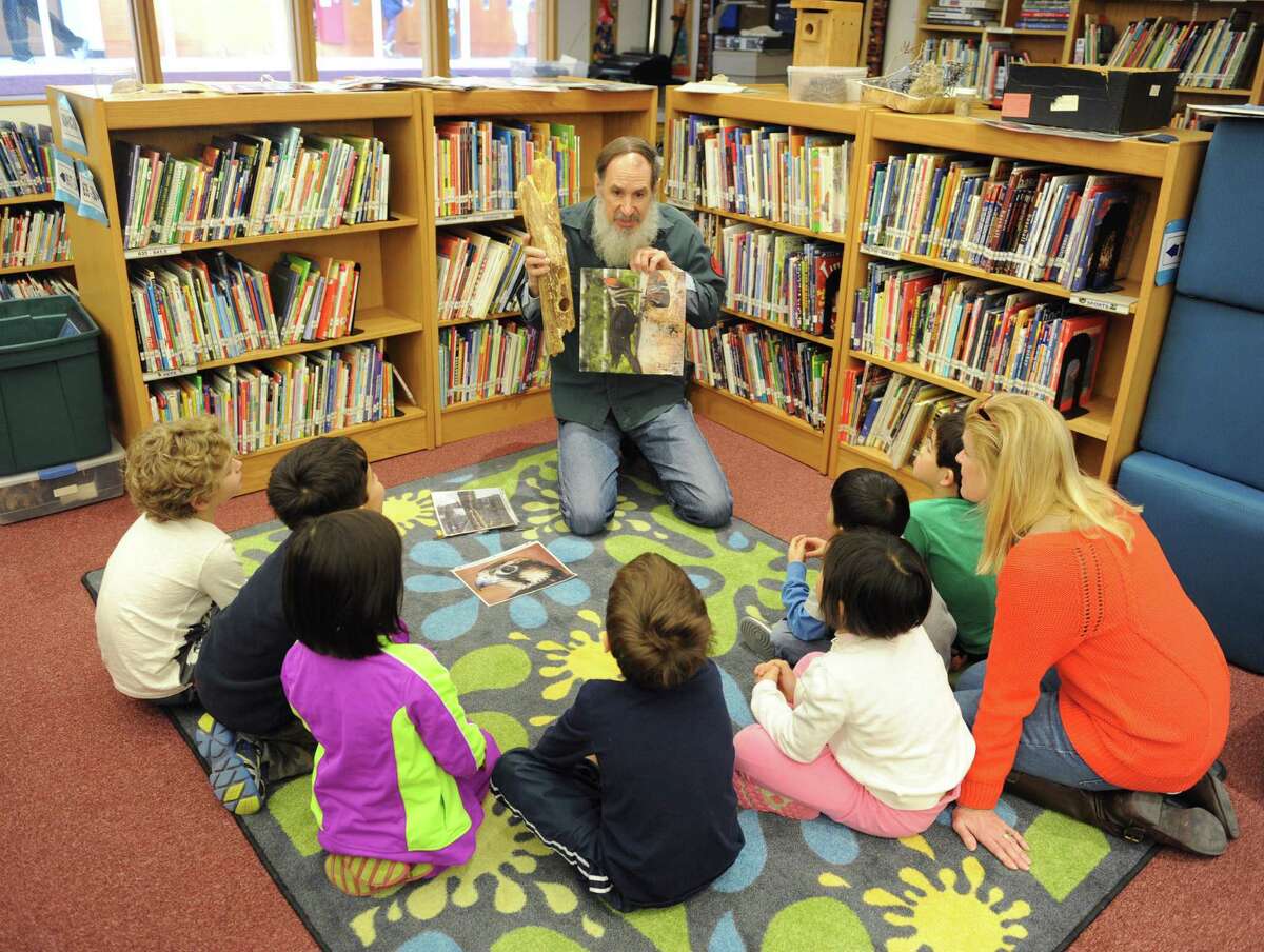Audobon Society Education Specialist Ted Gilman teaches a lesson in the new "learning commons" of the International School at Dundee in Old Greenwich, Conn. Thursday, Jan. 22, 2015. The school transformed its library media center into a much more interactive space where students spend more time doing hands-on activities. There is a new "maker space" where students create CAD designs to print with a 3D printer, different teaching spaces often incorporating outside programs and STEM activities all while keeping the elements of a traditional library media center.