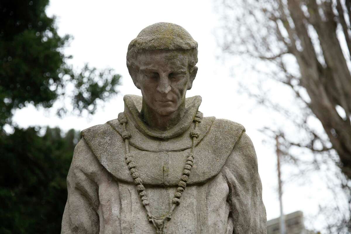 A stature of Father Junipero Serra done in the 1930s watches over the cemetery at the Mission Dolores.