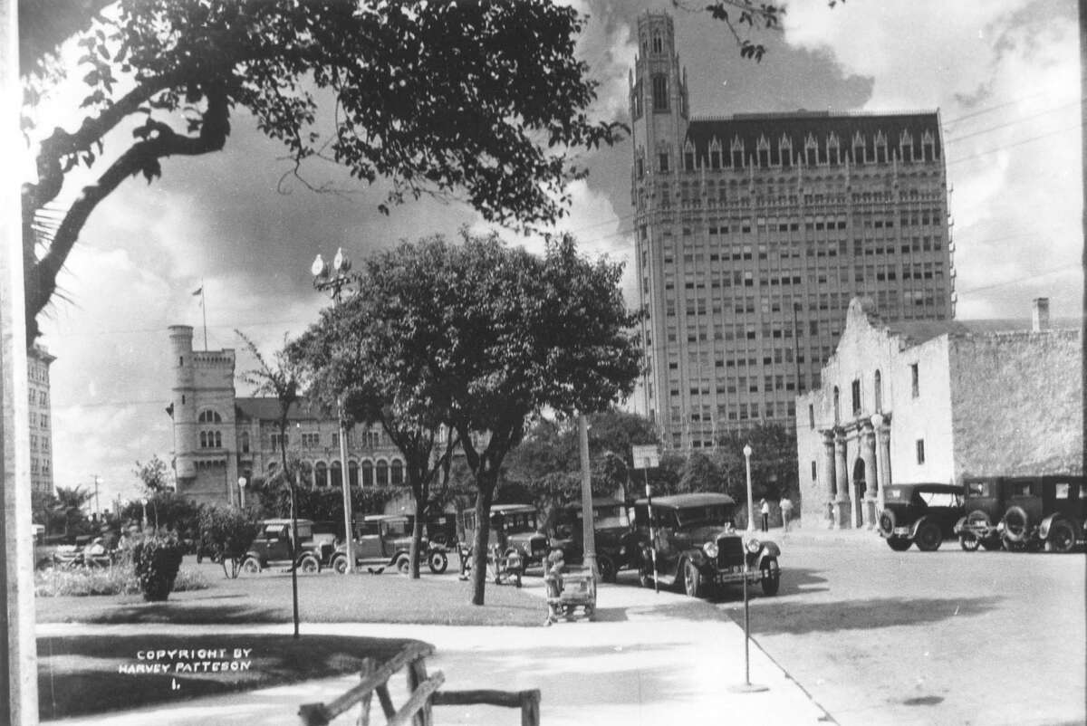 The Alamo and Alamo Plaza. Photo is labeled as being from 1920-1930, but it would then have to be late 1920s because of the Medical Arts (now the Emily Morgan Hotel) building in the background. The Federal building is to the left behind the trees. Photo by Harvey Patteson. Courtesy of the Harry Ransom Center