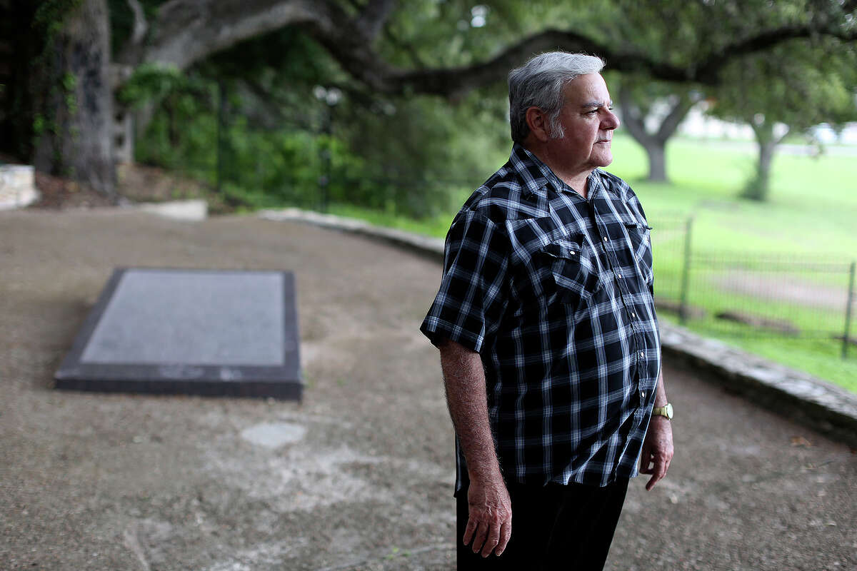 Albert Seguin Gonzales, of Texas City, stands at the burial site of his fourth great grandfather, Alamo defender Juan Seguin, in Seguin on Oct. 3, 2013.