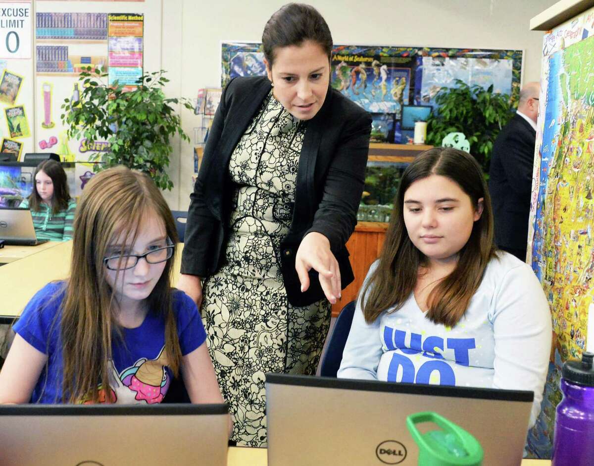 Congresswoman Elise Stefanik, a member of the House Committee on Education and the Workforce, looks over the work of 5th graders Avery Scatena, left, and Alison Lee during her tour of Gordon Creek Elementary School Friday Jan. 23, 2015, in Ballston Spa, NY. (John Carl D'Annibale / Times Union)