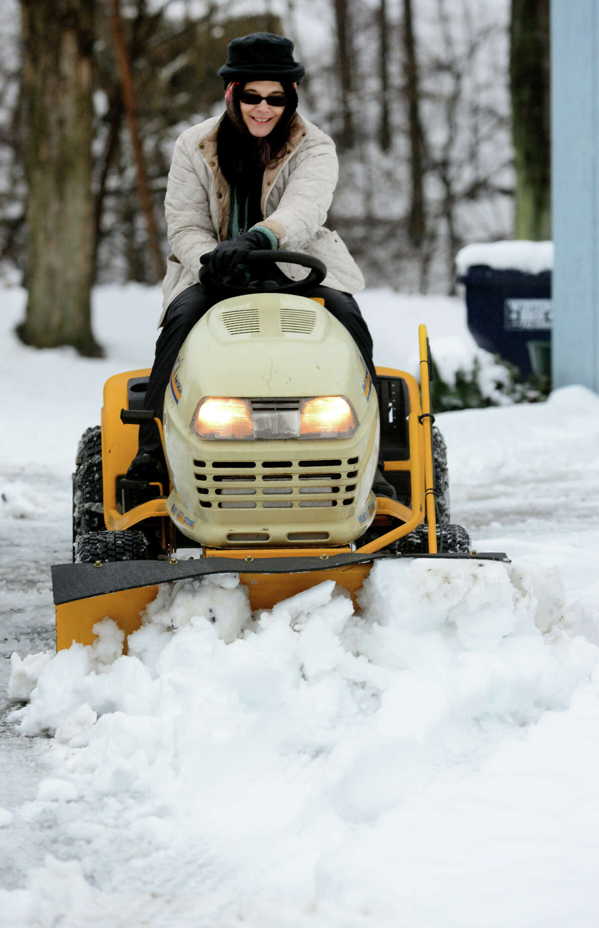 Donna Cherhoniak plows snow with her Cub Cadet plow at her home along Derby Avenue in Seymour, Conn. on Saturday Jan. 24, 2015. Cherhoniak said she got the plow on Craigslist with every attachment available and this was the first time she got to use it.