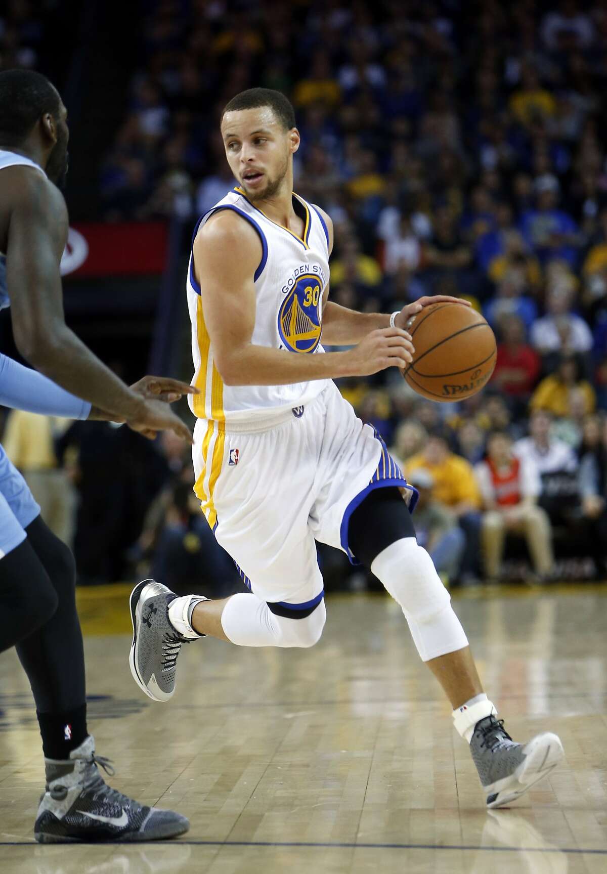 Golden State Warriors' Stephen Curry dribbles against Denver Nuggets during NBA game at Oracle Arena in Oakland, Calif. on Monday, January 19, 2015.