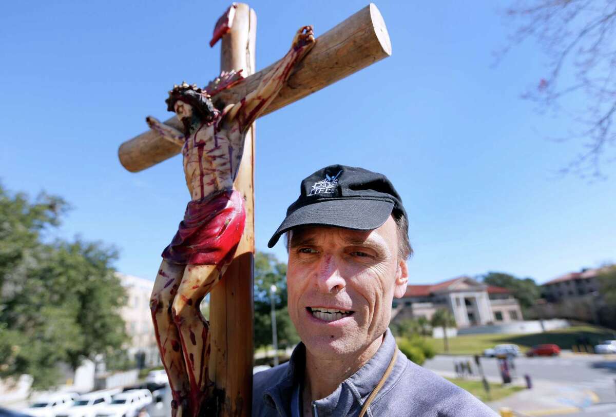 Richard Mahoney, holds a crucifix outside of an all-day prayer rally headlined by Gov. Bobby Jindal, Saturday, Jan. 24, 2015, in Baton Rouge, La. Jindal continued to court Christian conservatives for a possible presidential campaign with a headlining appearance at an all-day prayer rally hosted by the American Family Association. (AP Photo/Jonathan Bachman)
