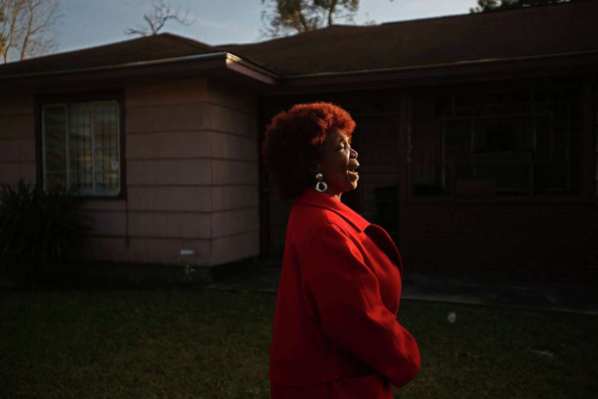 "Thank you God," shouts Evelyn J. Pierce, 66, while she stands outside her home which will be torn down to build a new house.﻿