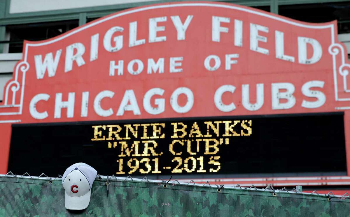 A Cubs hat hangs on the construction fence in front of Wrigley Field in honor of Ernie Banks, who died Friday night at age 83 in Chicago.