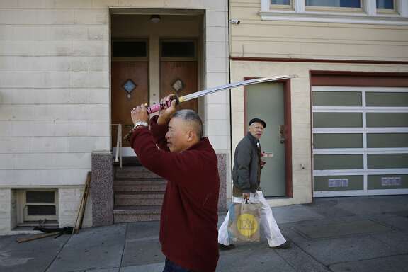 Stroke victim and student of the Japanese martial art know as aikido, Tim Sum, 70, shows off his ceremonial sword near his apartment in San Francisco, Calif. on Monday January 19, 2015 in Alameda, Calif.