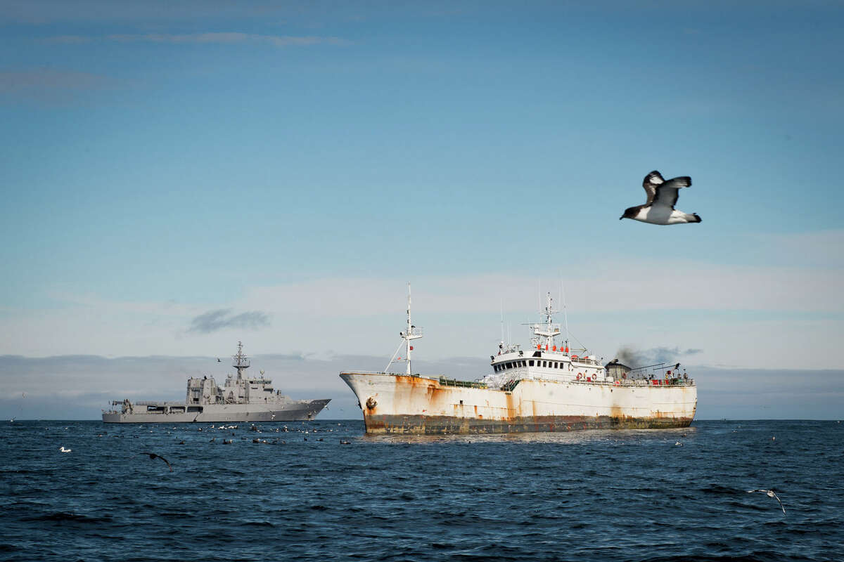 This Jan. 14, 2015 photo provided by the Royal New Zealand Navy shows the illegal fishing boat the "Kunlun." foreground, in the Southern Ocean off the coast of New Zealand. According to the Interpol summary, the Kunlun is owned by a shell company in Panama. It has been called the Black Moon, the Galaxy and the Chang Bai, among other names, and has been registered in North Korea, Sierra Leone, Tanzania, Panama, Indonesia and Equatorial Guinea.