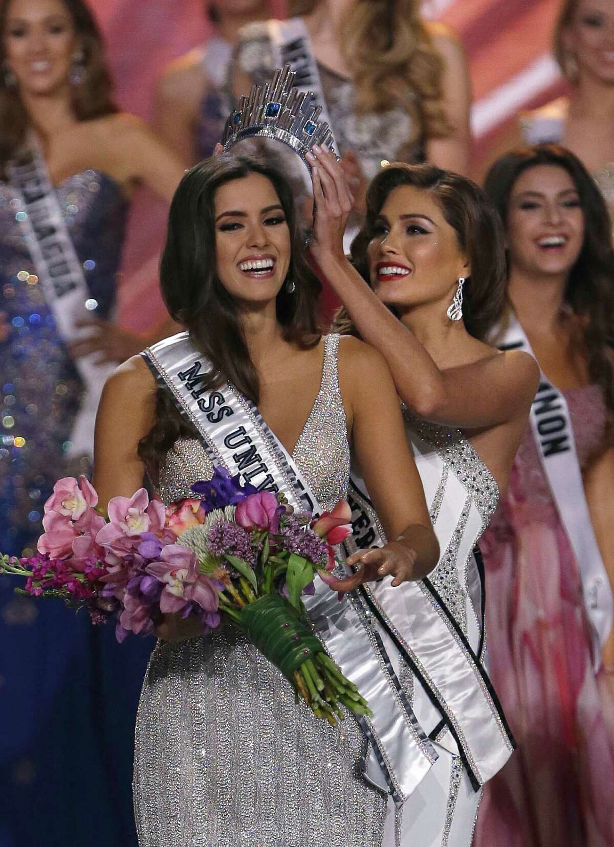 Reigning Miss Universe Gabriela Isler, right, crowns the new Miss Universe, Paulina Vega of Colombia, left, during the Miss Universe pageant in Miami, Sunday, Jan. 25, 2015.