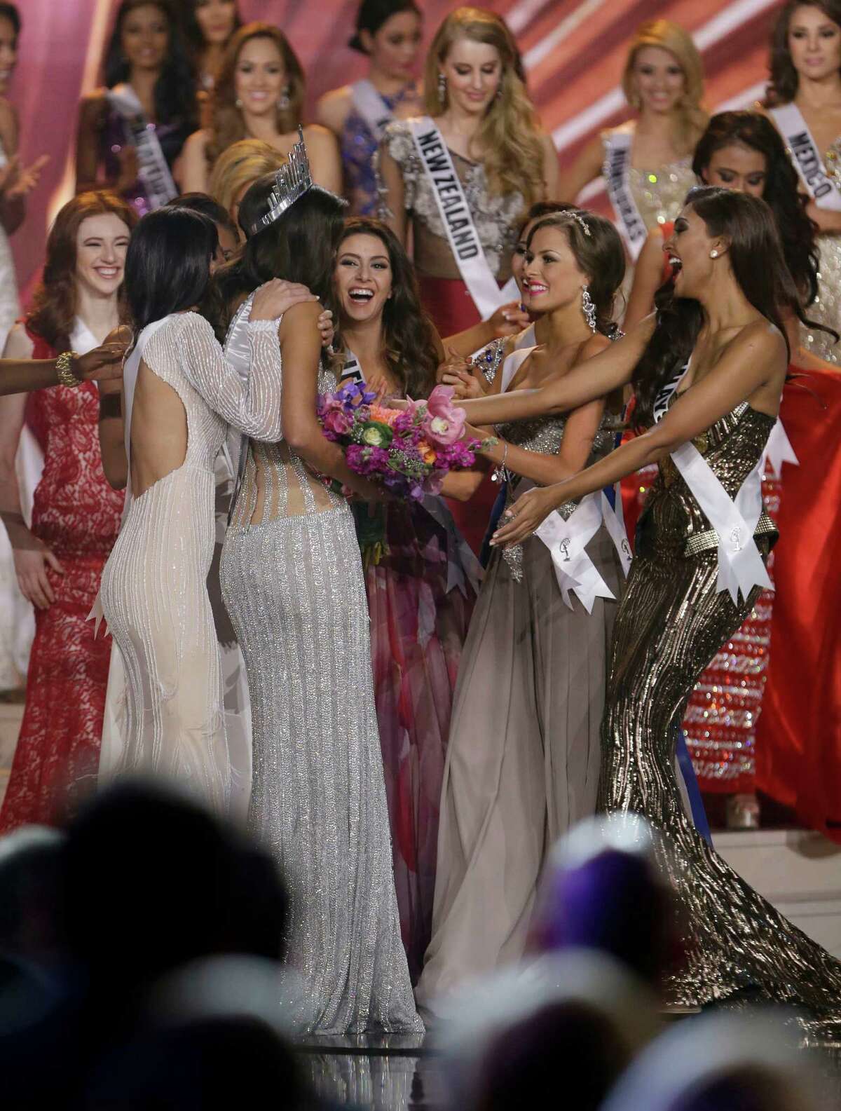 Miss Colombia Paulina Vega is congratulated by contestants after becoming Miss Universe at the Miss Universe pageant in Miami, Sunday, Jan. 25, 2015.