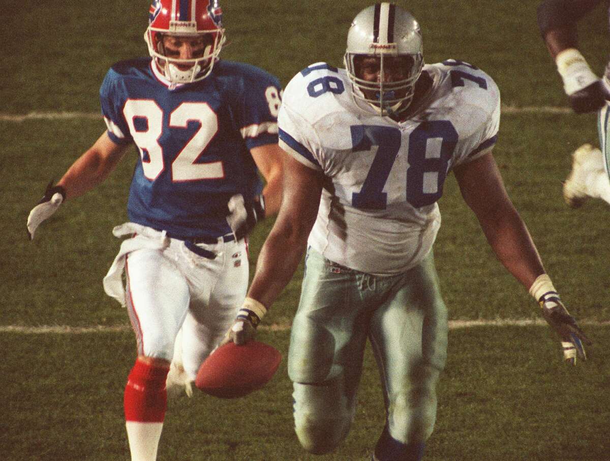Dallas Cowboys Leon Lett (78) begins to celebrate too early as he heads for the goal line after recovering a Buffalo Bills fumble during Super Bowl XXVII, Jan. 31, 1993. Bills Don Beebe, left, stripped the ball from Lett just before Lett crossed the line, turning the ball back over to Buffalo. The Cowboys defeated the Bills, 30-13. (AP Photo/Douglas C. Pizac)