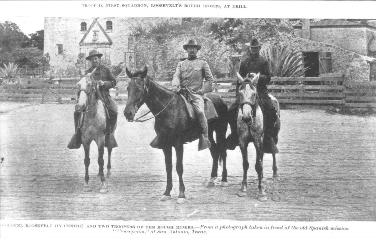 Theodore Roosevelt and two of his Rough Riders on horses in front of Concepcion Mission. San Antonio, circa 1898.
