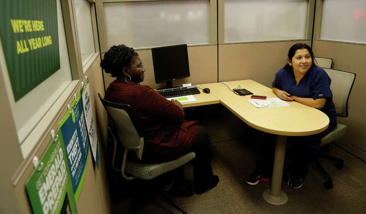 H&R Block office manager Dianne Butler, left, sits with her client Claudia Chacon as she talks about her ability to avoid paying a penalty for not buying insurance last year while doing her taxes at H&R Block at 9474 Hammerly Blvd. Wednesday, Jan. 21, 2015, in Houston. This is the first tax filing season for those consumers who bought insurance in the health insurance marketplace. They are going to have to complete extra paperwork to determine whether the premium subsidies they received were for the correct amount. ( Karen Warren / Houston Chronicle )
