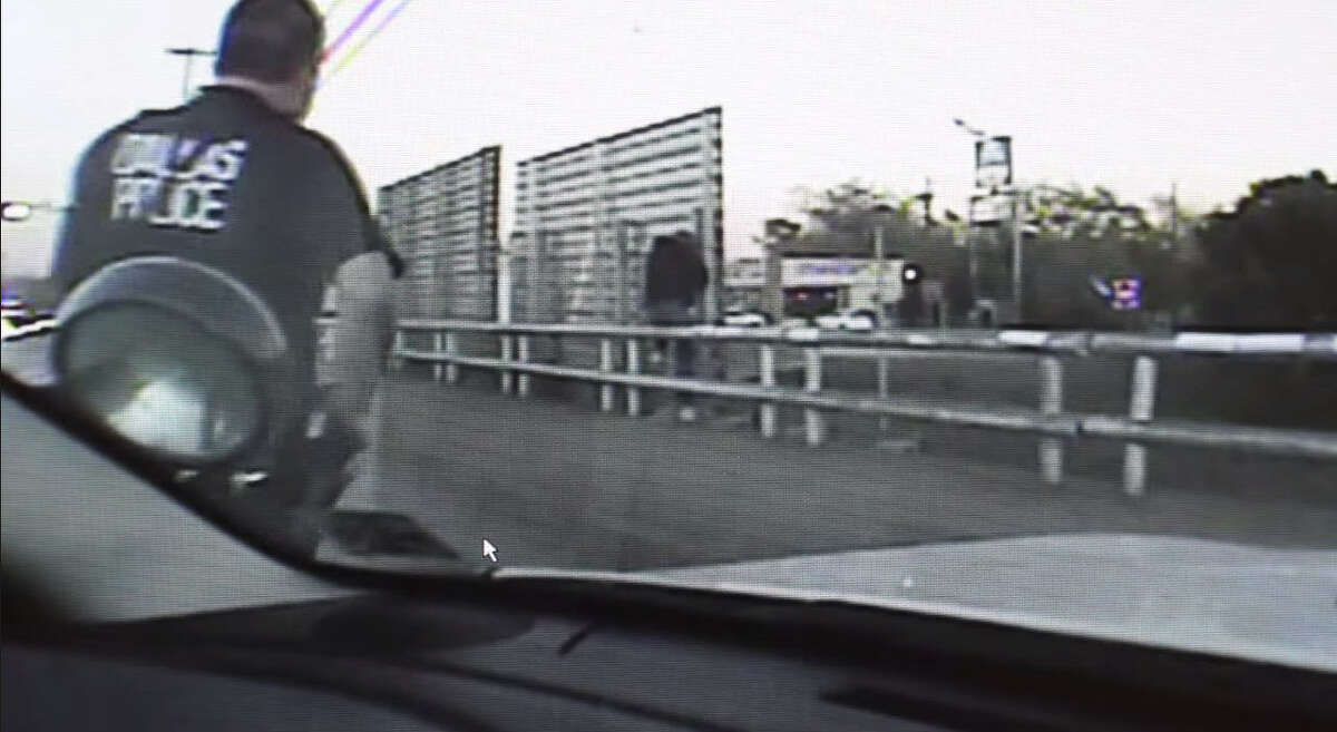 Two Dallas Police officers converge on a man about to jump off the Martin Luther King overpass into the traffic below on S.M. Wright Freeway on Nov. 26, 2014. Officer D. Mulvihill approaches from the right while Sgt. McCoy distracted the subject from the left. The tactics allowed Mulvihill to reach the man unseen and subdue him before jumping.
