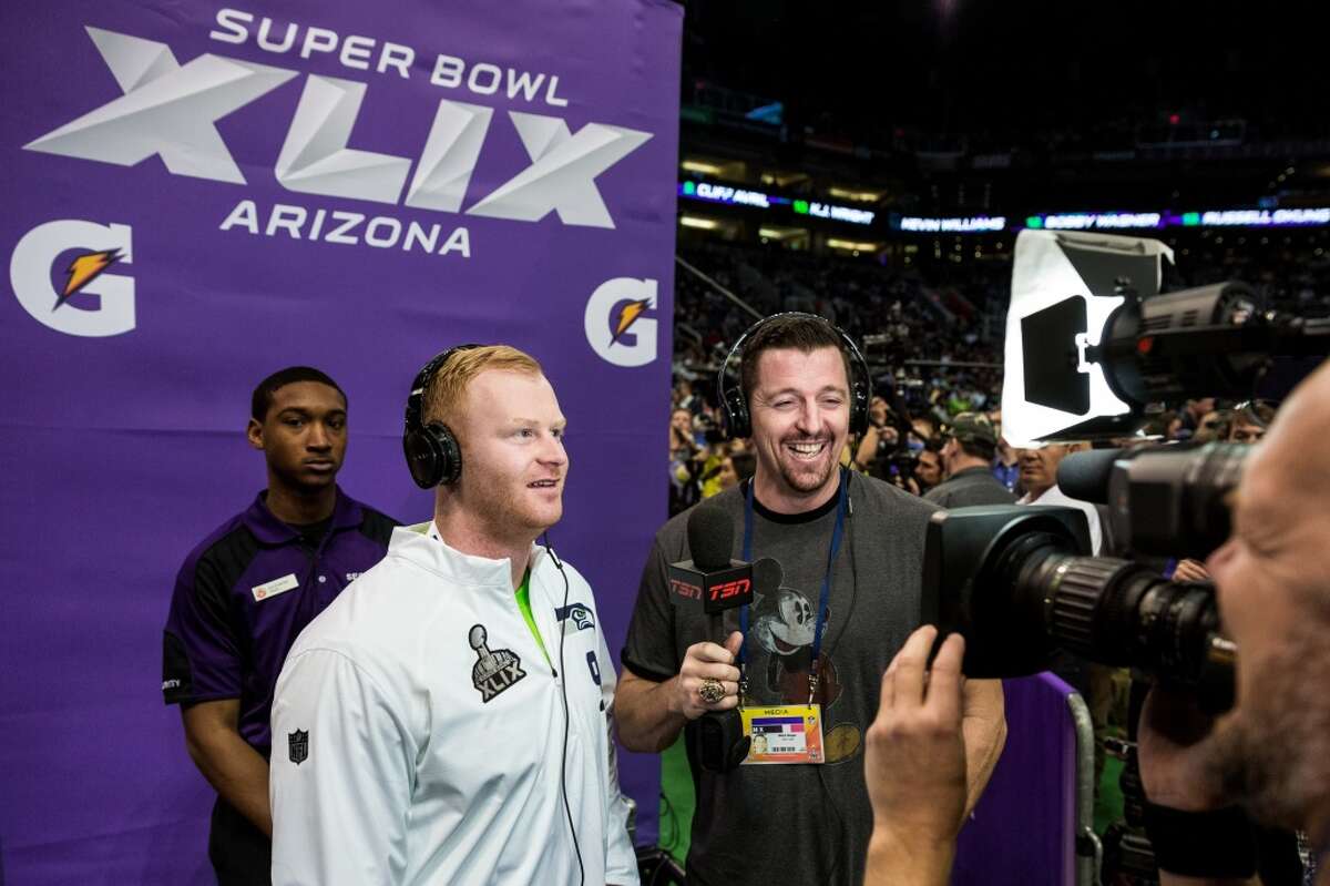 Jon Ryan, left, answers questions during Super Bowl XLIX Media Day Tuesday, January 27, 2015, at the US Airways Center in Phoenix, Arizona.