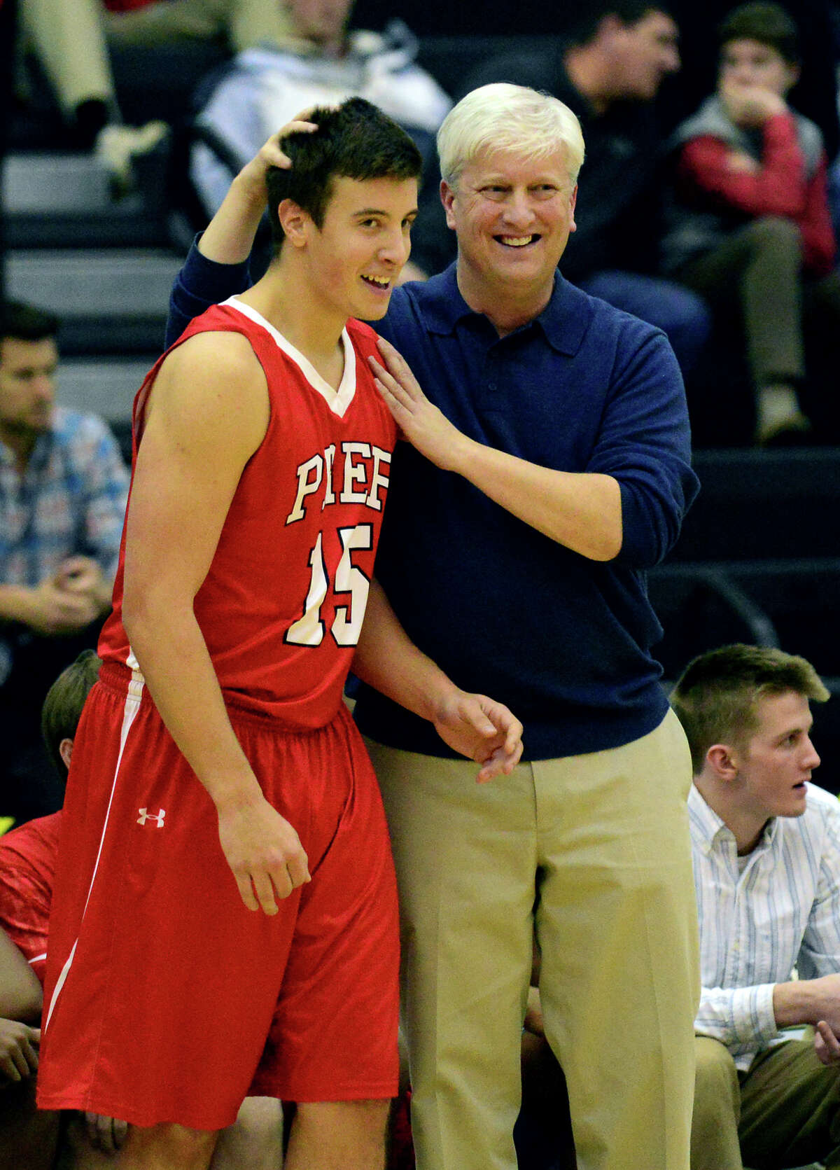 Fairfield Prep Head Coach Leo Redgate with player Joseph DiGennaro, during boys basketball action against Career Magnet in New Haven, Conn., on Wednesday Jan. 14, 2015.